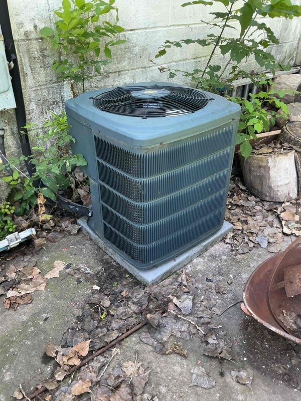 Responded to no cooling call on 13-year-old residential air conditioning system. Upon arrival, tenant reported unit made loud noise prior to failure and had hosed down the condenser. Diagnostic testing revealed compressor overload protector stuck in open position, preventing compressor operation. Verified compressor temperature was normal to touch and attempted to obtain amperage reading, but compressor failed to start. System inspection identified complete loss of refrigerant charge. Based on tenant report of effective cooling operation one week prior to failure, assessment indicates probable large refrigerant leak in system. Reviewed repair and replacement options with property owner and scheduled follow-up consultation with service advisor for further recommendations.