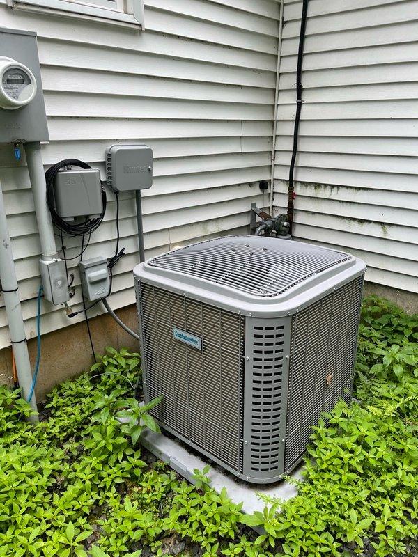 Performed comprehensive air conditioning tune-up and addressed cooling concerns for second floor. Upon arrival, identified open registers on basement trunk line contributing to inadequate upstairs cooling; reattached and closed basement vents to redirect airflow. Inspected indoor components including filter, evaporator coil, and blower assembly—all found clean with proper condensate drainage. Conducted electrical inspection on outdoor condensing unit with all readings within manufacturer specifications. Cleaned dirty condenser coil to restore optimal heat transfer efficiency. Performed operational test with 15-minute runtime, confirming proper system function with temperature split exceeding 20 degrees across the evaporator coil. Discussed zoning options including potential T10 thermostat with remote sensors, though homeowner elected to first evaluate results of redirected airflow from closed basement registers. System operating properly at departure.
