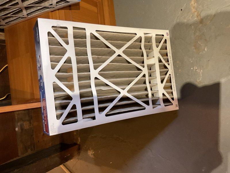 Performed comprehensive air conditioning maintenance on a 1992 Trane R-22 system. Condenser coil was completely impacted with debris and required thorough cleaning from the inside out using coil soap and wash wand to restore proper airflow. All electrical components tested within acceptable specifications; noted slight contactor chatter that should be monitored going forward. 

At the indoor unit, discovered filter installed in an older Honeywell electronic air cleaner cabinet with power still connected. Disconnected power to the electronic air cleaner and removed lower retaining screw to facilitate easier filter access for homeowner. Evaporator drain pan exhibited mold and mildew buildup with partial blockage; cleaned drain pan and verified drain line flowing freely to floor drain with no restrictions. 

System operational with 20°F temperature split achieved at time of service. Documented conditions with photos for homeowner review. Homeowner aware of system age and planning replacem