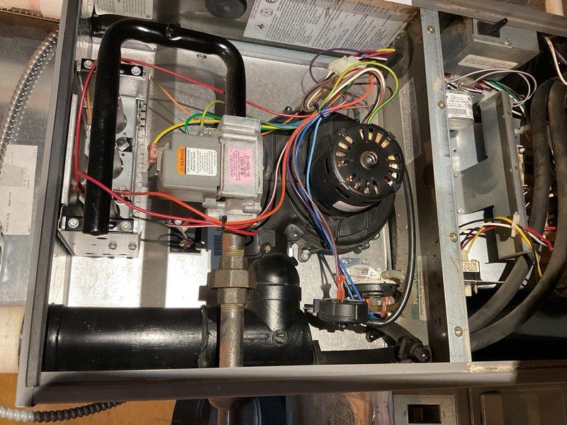 Performed comprehensive air conditioning maintenance on a 1992 Trane R-22 system. Condenser coil was completely impacted with debris and required thorough cleaning from the inside out using coil soap and wash wand to restore proper airflow. All electrical components tested within acceptable specifications; noted slight contactor chatter that should be monitored going forward. 

At the indoor unit, discovered filter installed in an older Honeywell electronic air cleaner cabinet with power still connected. Disconnected power to the electronic air cleaner and removed lower retaining screw to facilitate easier filter access for homeowner. Evaporator drain pan exhibited mold and mildew buildup with partial blockage; cleaned drain pan and verified drain line flowing freely to floor drain with no restrictions. 

System operational with 20°F temperature split achieved at time of service. Documented conditions with photos for homeowner review. Homeowner aware of system age and planning replacem