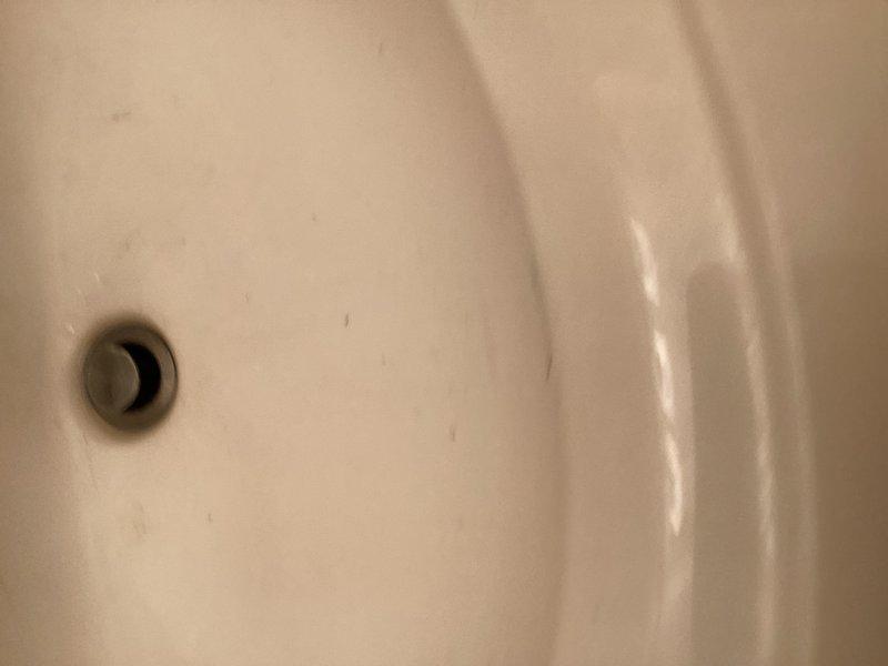 Completed comprehensive plumbing inspection for member, examining fixtures and water flow systems throughout the property. Inspected bathroom fixtures including sink basin, drain assembly, and shower/tub faucet controls to assess overall plumbing condition and discussed potential water softener installation for future consideration.