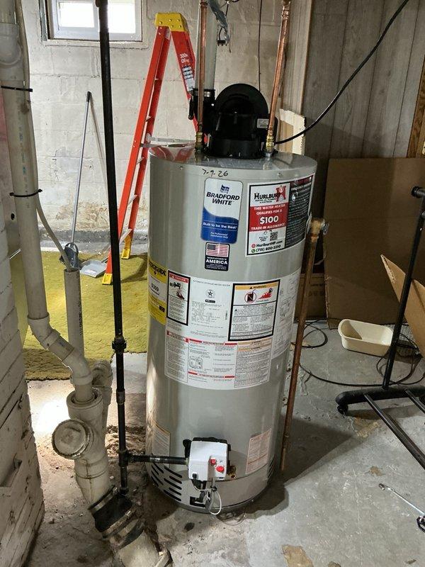Responded to request for estimate on rerouting water heater venting due to upcoming roof replacement eliminating existing chimney penetration. Assessed current configuration with standard atmospheric venting through chimney and provided options for alternative venting solutions. Customer approved installation of power vent conversion system to eliminate need for vertical chimney vent.

Removed existing 40-gallon natural gas atmospheric vent water heater and associated chimney venting. Installed new 40-gallon natural gas power vent water heater with Bradford White power vent motor assembly. Rerouted exhaust venting horizontally through basement wall to exterior of structure using PVC vent piping system. Reconfigured cold water supply and hot water distribution piping to new unit location. Connected natural gas supply line to new water heater per manufacturer specifications.

Pressurized system and performed leak check on all water connections, gas connections, and vent terminations. Ver