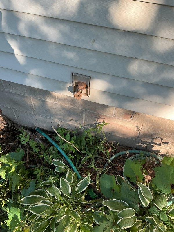 Responded to service call for leaking outdoor hose bibb that was previously installed approximately 2.5 years ago. Upon inspection, discovered the hose bibb had suffered freeze damage due to improper back-grading during original installation. The unit had split from freeze break, requiring complete replacement. Removed the failed hose bibb and installed new frost-free hose bibb with proper grading to prevent future freeze damage. Verified all connections were secure and tested operation to ensure no leaks. Restored water supply to the exterior spigot.