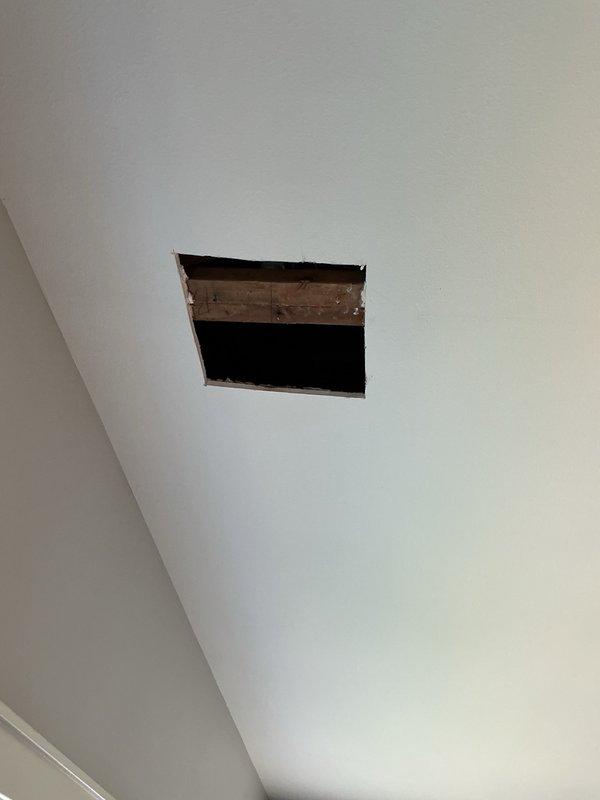 Responded to a water leak originating from a second-floor bathtub that was causing water intrusion into the first-floor ceiling. Upon investigation, identified the source as a faulty overflow plate gasket on the bathtub. Created an access opening in the affected first-floor ceiling drywall to confirm the leak location and assess moisture damage to the underlying structure. Disassembled the bathtub overflow assembly, replaced the deteriorated gasket with a new one, and reassembled all components to manufacturer specifications. Advised monitoring the repair area for any additional signs of moisture intrusion.