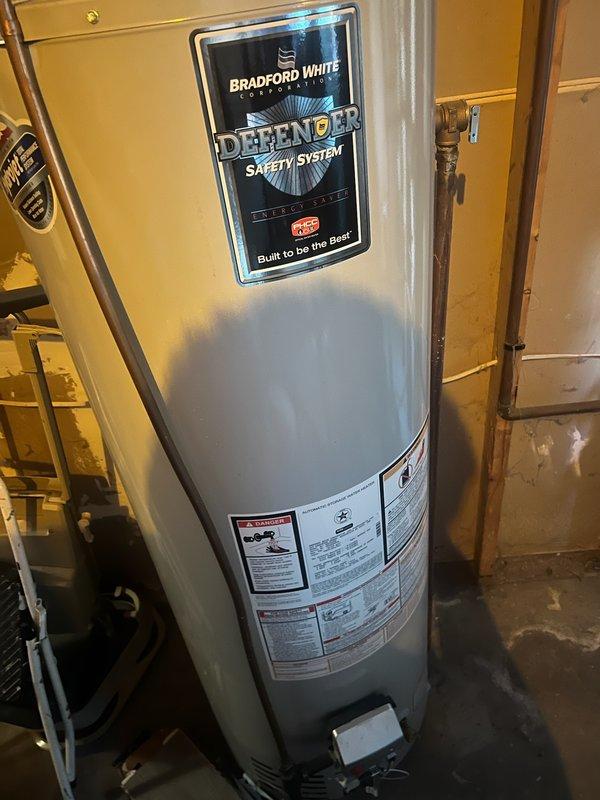 Responded to no hot water complaint and found existing water heater leaking and corroded beyond repair. Completed full plumbing inspection and installed new Bradford White Defender Safety System water heater to restore hot water service to the property.