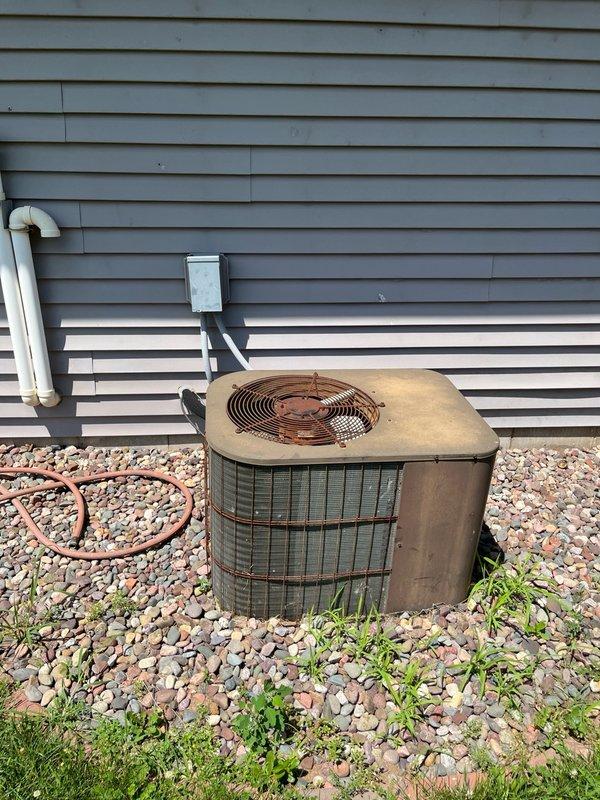 Responded to no cooling complaint on 10-year-old air conditioning system. Upon arrival, found outdoor unit fan motor operating but compressor not running. Performed diagnostic inspection of electrical components and identified failed compressor capacitor reading approximately 4 microfarads instead of rated 30 microfarads. Replaced defective compressor capacitor with proper replacement. Tested system operation and confirmed compressor engaged properly. Measured temperature split of approximately 15 degrees across evaporator coil and verified refrigerant pressures within acceptable range. During inspection, observed contactor showing significant pitting on contact surfaces and condenser fan motor exhibiting stiffness during rotation, indicating these components are nearing end of service life. Advised customer of deteriorating condition of remaining electrical components and recommended obtaining replacement system pricing given the age of equipment and cumulative repair costs, as curren