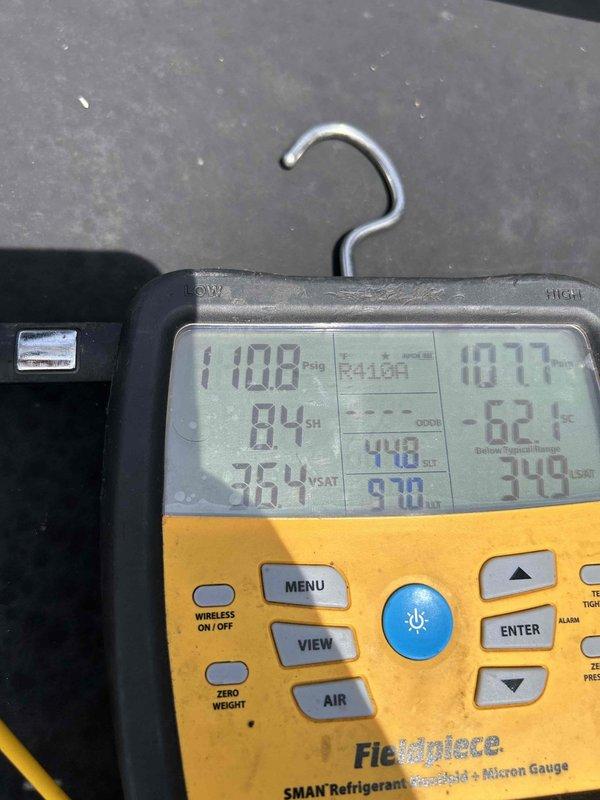 Responded to service call for Lennox mini-split system experiencing intermittent cooling failure after approximately 20 minutes of operation. Accessed rooftop unit and performed diagnostic testing using refrigerant manifold gauges, which revealed system operating with R410A refrigerant at pressures of 110 PSI low side and 107 PSI high side. Upon inspection, discovered blower wheel heavily contaminated with dirt and debris, restricting airflow and causing system to shut down on safety controls. Documented equipment condition and refrigerant pressures; scheduled follow-up visit to perform complete blower wheel cleaning with pump and chemical cleaner to restore proper airflow and system performance.