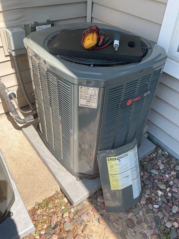 Responded to no cooling call on a 2-year-old Trane system that was not turning on. Upon arrival, discovered rodent damage to low-voltage wiring inside the outdoor condenser unit. Mice had chewed through control wires, causing a short circuit that prevented system operation. Repaired damaged wiring, restored electrical connections, and sealed entry point with silicone to prevent future rodent intrusion. System tested and returned to normal operation.