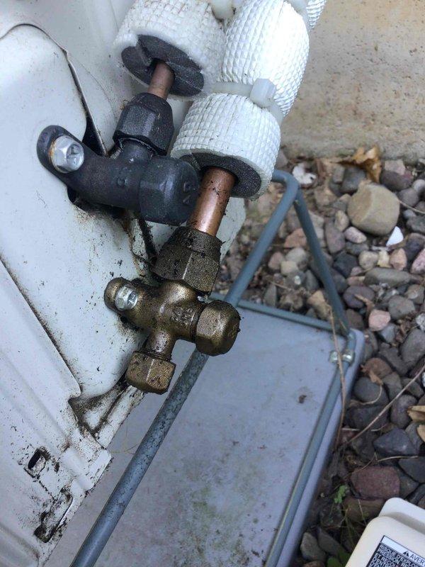 Responded to no cooling complaint on 2-year-old mini split system. Found indoor and outdoor units running but system not providing cooling to space. Upon inspection, discovered complete refrigerant loss due to leak at outdoor unit flared connection fitting. Brass service valve and flare fitting showed improper installation with visible signs of refrigerant leak at connection point. System was operational but unable to cool due to zero refrigerant charge. Created installation correction documentation for repair team to return, properly remake flared connection, pressure test system, and recharge to factory specifications. Customer notified that office will schedule follow-up appointment for corrective work.