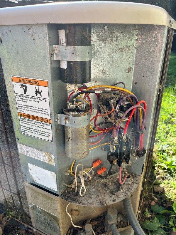Responded to no cool call with outdoor unit squealing and condenser fan not operating. Upon arrival, found condenser fan motor locked up and seized. Freed up motor shaft to restore temporary operation and system cooling. Diagnostic testing revealed capacitor out of specification on hermetic terminal, contactor showing pitting and wear, and R22 refrigerant charge low. Connected manifold gauges to verify system pressures and refrigerant levels. Given the age of the unit and multiple component failures, provided estimates for condenser fan motor replacement to customer for consideration.