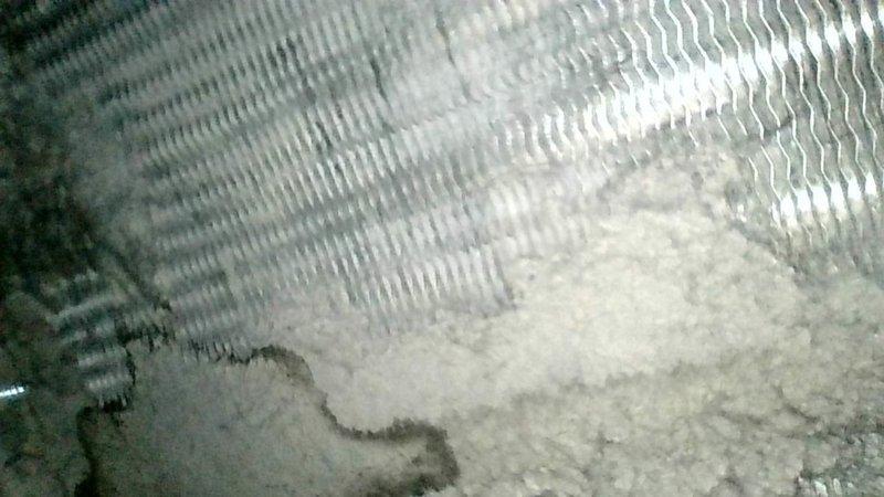Responded to no cooling complaint on 18-year-old R-22 system with reported evaporator coil icing and poor airflow. Upon arrival, confirmed history of repeated freeze-ups and diminished airflow even after ice had melted. Performed system inspection and found primary evaporator coil heavily contaminated with dirt and debris, significantly restricting airflow. Secondary coil also showing accumulation but less severe. Blower assembly in acceptable operating condition. 

Inspected outdoor condensing unit and verified compressor and fan motor operation. Tested run capacitor on hermetic compressor circuit and found readings out of specification. Observed contactor with pitting on contact points indicating electrical wear. Explained to occupant that heavily soiled evaporator coil was root cause of both inadequate airflow and coil icing conditions. Advised that accurate refrigerant pressure analysis cannot be performed until airflow restriction is eliminated through proper coil cleaning.

Provi