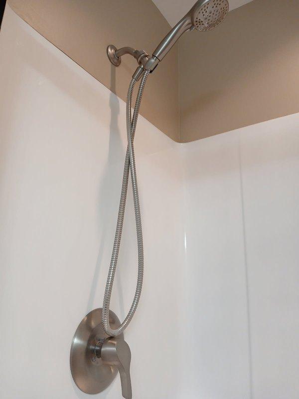 Responded to a leaking shower complaint and diagnosed a faulty cartridge as the source of the leak. Removed the defective cartridge and installed a replacement unit, restoring proper function to the shower system. The dual showerhead fixture now operates without leakage.