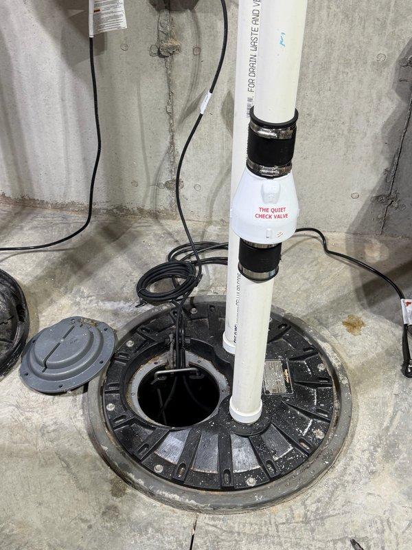 Responded to a backup issue at the floor drain caused by a malfunctioning ejector pump. Upon inspection, identified a failed float switch and partial obstruction in the pit drain outlet line. Cleared the blockage from the drain outlet, replaced the defective float switch with a new unit, and installed a 2-inch check valve to prevent backflow. System tested and restored to proper operation with no further backup issues observed.