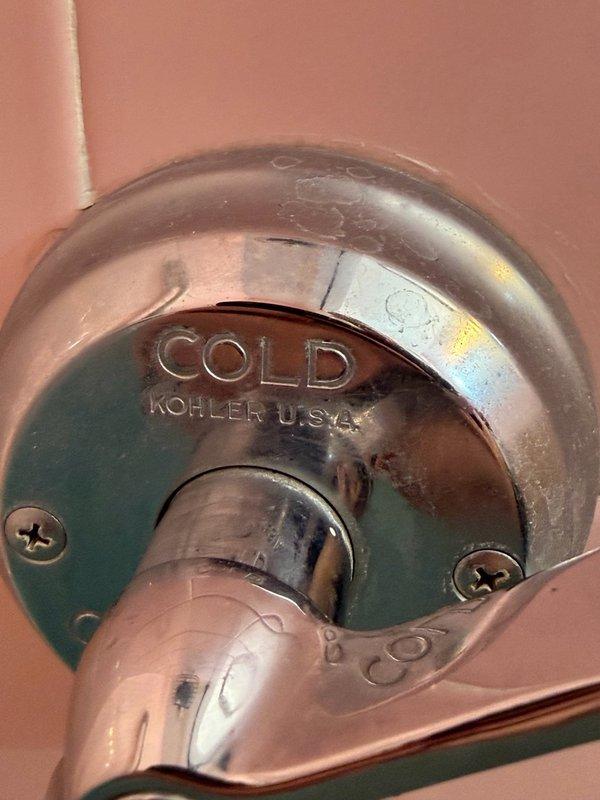Responded to service call for bathtub faucet experiencing continuous dripping and difficulty operating the on/off function. Upon inspection, diagnosed faulty Kohler tub-shower cartridge requiring replacement. The existing cartridge showed significant age-related deterioration with visible water staining and corrosion on the chrome-finished trim components. Documented the installation with photographs and identified the replacement part as a Kohler OEM Niedecken Cartridge Assembly (long style, complete). Completed part order form and submitted to parts department for pricing and procurement to schedule cartridge replacement.