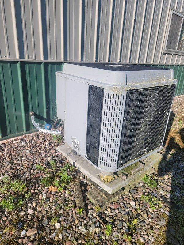 Responded to no-cool call on 22-year-old R22 central air system with reported buzzing noise and non-operational outdoor fan. Diagnosed and replaced failed capacitor on condenser unit, restoring system operation. Performed system verification including refrigerant pressure check (pressures within acceptable range), confirmed 18-degree temperature drop across evaporator coil, cleared condensate drain line, and verified condenser coil cleanliness. Advised homeowner that due to system age and R22 refrigerant phase-out, major repairs may not be cost-effective moving forward. Unit currently operational and cooling properly.