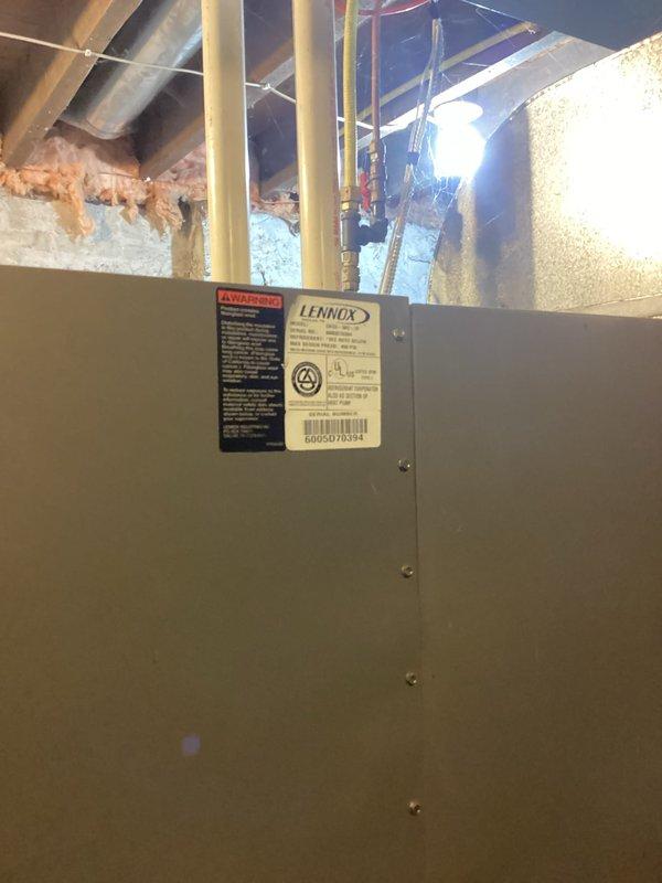 Responded to no cooling complaint on a Lennox central air conditioning system approximately 10 years old at a rental property. Upon inspection, discovered heavily soiled condenser unit with significant debris accumulation in base pan and deteriorated insulation in equipment compartment. Compressor was overheated due to system restriction affecting refrigerant flow, preventing proper cooling operation. Diagnosed refrigerant restriction causing compressor failure and loss of cooling capacity. Provided estimate for complete system replacement due to age and extent of mechanical failure.