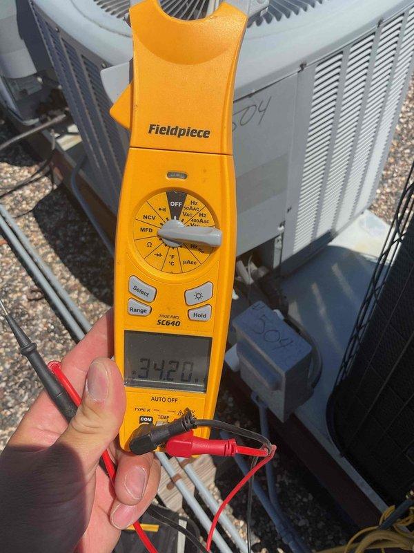 Performed AC tune-up on rooftop unit, accessing roof with key from front desk. Found dirty 20x20x1 filter and low capacitor during inspection. Replaced failed capacitor and installed new air filter to restore system to proper operating condition.