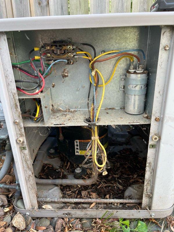 Responded to no cool call on 10-year-old central air conditioning system. Upon arrival, found thermostat calling for cooling but compressor not running and condenser fan spinning at extremely low RPM. Diagnosed failed dual-run capacitor affecting both compressor and fan motor operation. Fan motor was excessively hot to touch with burnt odor present from prolonged operation at reduced speed. Contactor showed significant pitting on contact points.

Discussed findings with homeowner and explained that while capacitor replacement would restore immediate operation, the fan motor showed signs of thermal damage from running under failed capacitor conditions. Homeowner authorized capacitor replacement to restore cooling function. Installed new dual-run capacitor and energized system for testing. Compressor and condenser fan motor operated normally. Verified system pressures were within acceptable range during test cycle.

Due to observed conditions of fan motor (thermal damage and burnt odor),