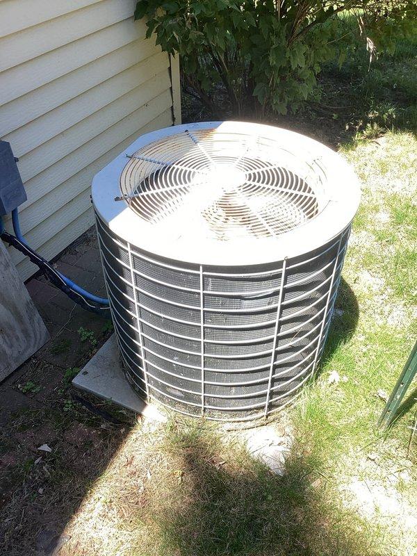 Completed comprehensive air conditioning maintenance visit on residential cooling system. Upon arrival, homeowner confirmed unit was operating properly with no reported concerns. Performed standard AC tune-up procedures including temperature split verification, which measured within acceptable parameters. Inspected outdoor condenser unit with protective cage guard on concrete pad—found equipment to be aged but functioning adequately with normal weathering. Examined indoor air handler components, noting significant dust and debris accumulation on blower assembly, electrical connections, and interior compartment surfaces. System continues to provide adequate cooling performance despite age of equipment.