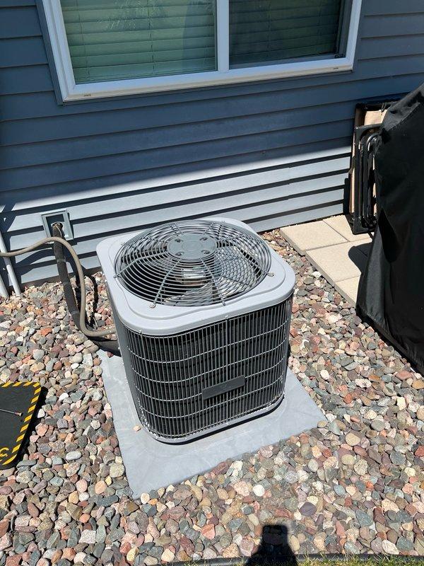 Performed comprehensive AC tune-up on residential split system of unknown age. Inspected outdoor condenser unit and found all components within manufacturer specifications; removed multiple wasp nests from around unit and electrical disconnect. Replaced dirty air filter with customer-supplied unit. Verified evaporator coil was clean with proper condensate drainage, and confirmed blower assembly was clean and properly balanced. Conducted operational test with 15-minute runtime, confirming system achieved 15-20 degree temperature differential across the coil, indicating proper refrigerant charge and airflow. All systems operating as designed with no deficiencies noted.