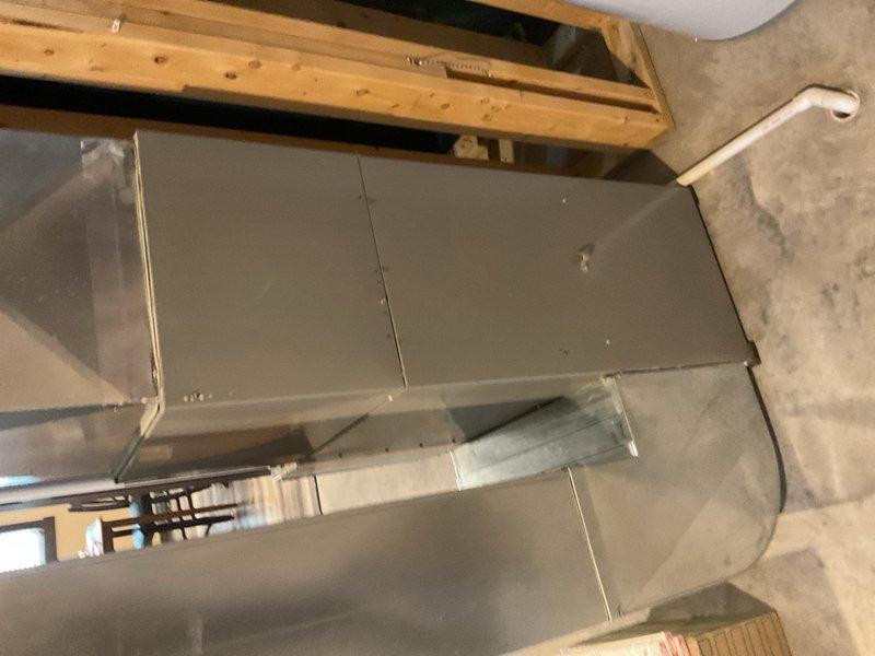 Responded to no-cool complaint on Tempstar/ICP F9MVE0601714A1 variable-speed gas furnace system with R-410A air conditioning unable to maintain setpoint and remove humidity. Customer reported cherry-like odor suspected to be refrigerant leak. Performed complete system diagnostics on 95°F outdoor ambient day. Measured return air temperature at 74°F and supply air at 56°F, yielding 18°F temperature split. Recorded refrigerant pressures: suction at 129.6 psig, liquid line at 374.4 psig. Calculated superheat at 16.4°F and subcooling at 9.2°F against manufacturer target of 10°F, confirming refrigerant charge is correct and no leak present.

Observed abnormal ECM blower motor operation during initial testing. Removed 16x25x1 MERV 10 filter and immediately noted significant change in blower performance—ECM motor ramped down to normal operating parameters and audible noise normalized. This confirmed excessive static pressure across return-side filter causing restricted airflow, resulting in re