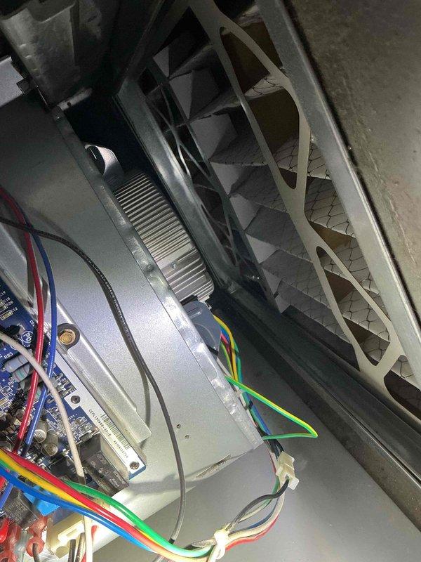 Responded to no cooling call on 8-year-old Carrier air conditioning system. Upon arrival, confirmed indoor blower motor was not operating. Performed diagnostic testing on ECM blower motor and module, verifying proper high voltage supply to motor windings and correct DC signal voltage to the control module. Testing confirmed ECM blower module failure as motor would not respond to control signals despite proper electrical inputs. Documented equipment condition with photos showing air handler installation and internal blower assembly with wiring connections. Due to failed module preventing blower operation, unable to complete full system diagnosis as additional components may have been affected. Parts estimate request submitted for ECM blower module replacement to restore system operation.
