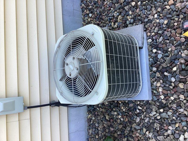 Responded to no-cooling call on 24-year-old residential air conditioning system. Upon arrival, confirmed outdoor condenser unit was not operating while indoor blower functioned normally when thermostat called for cooling. Performed diagnostic inspection of condenser components including capacitor, contactor, and compressor. Found failed capacitor preventing compressor operation. Replaced defective capacitor with proper replacement and cycled system to verify operation. Verified refrigerant charge levels within acceptable range. Conducted inspection of indoor air handler, including blower motor operation and evaporator coil condition. Noted evaporator coil showing rust and general system wear consistent with age and capacitor failure. Air filter found in acceptable condition, recently replaced. System restored to cooling operation and left running properly.