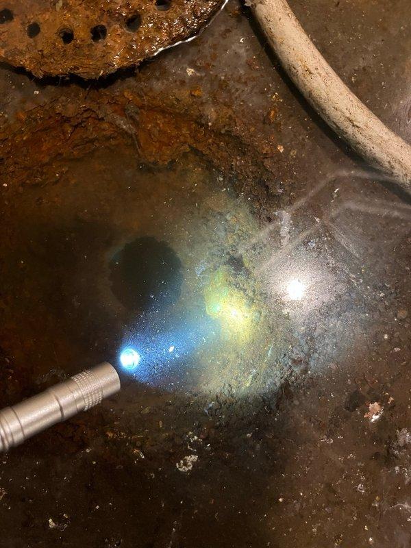 Responded to callback for AC unit installed 13 days prior with reported basement flooding from condensate drainage issue. Upon arrival, found significant water accumulation near furnace area with floor drain backing up and unable to handle discharge volume. Documented conditions with photos showing extensive water pooling on basement floor and compromised drainage system. Diagnosed clogged floor drain as primary cause preventing proper condensate removal. Scheduled plumber to snake drain line and advised that condensate pump installation with upstairs drain routing would be required if drain clearing unsuccessful.
