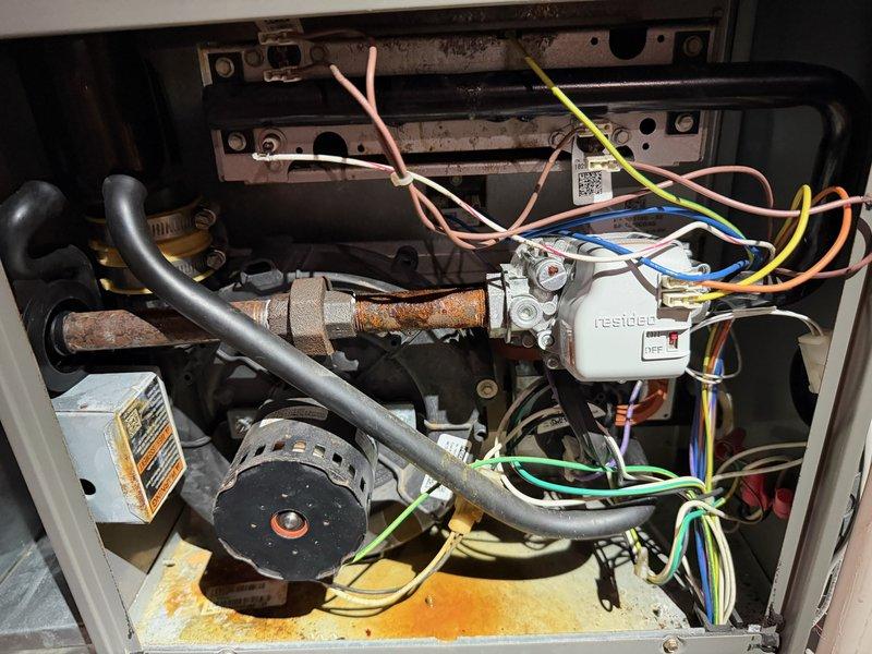 Responded to urgent water leak complaint at furnace system. Upon inspection, determined water intrusion was occurring through the outdoor fresh air intake vent located near exterior landscaping. Identified that water from plant watering and sprinkler system was entering directly through the intake pipe, causing moisture accumulation in the furnace compartment. Advised homeowner to redirect watering practices away from the intake vent to prevent future water intrusion and potential damage to internal furnace components.