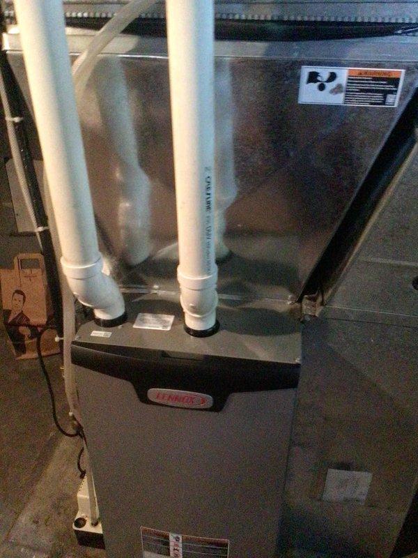 Completed comprehensive air conditioning tune-up on 4-year-old Lennox HVAC system as part of maintenance agreement. Performed outdoor unit cleaning, conducted complete electrical testing with all readings within manufacturer specifications, replaced air filters, and verified system performance with 20-degree temperature split across evaporator coil. Unit operating properly with no deficiencies noted.