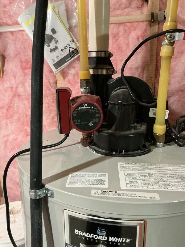 Removed and disposed of a corroded and leaking hot water recirculation pump from the residential water heater system. Installed a new Grundfos recirculation pump with timer control, ensuring all connections were properly secured to existing piping infrastructure. Bled all hot water lines throughout the system to remove air pockets and verified proper circulation and pump operation. During inspection, identified a corroded nipple fitting on the water heater outlet that will require future monitoring and potential replacement. Tested the complete system for leaks and confirmed the new pump was cycling correctly according to timer settings. Installation includes a 1-year parts and labor warranty. Customer was advised of the corroded fitting condition but declined additional repairs at this time.