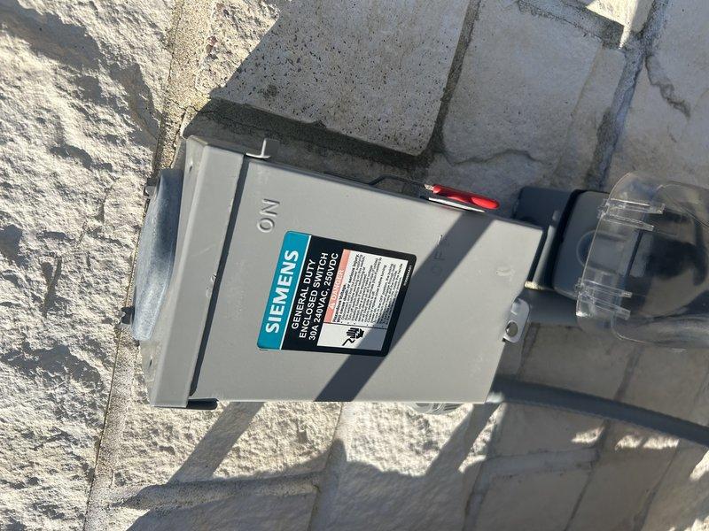 Responded to no cooling complaint on commercial Samsung mini-split cassette system. Upon arrival, found exterior disconnect switch in off position and E507 error code displayed on outdoor unit control board indicating high pressure switch fault. Performed diagnostic testing with multimeter across high pressure switch jumper terminals, measuring 0V DC instead of required 12V DC, while low pressure switch circuit tested correctly at 12V DC. Consulted with technical support and attempted jumper bypass test with no results, confirming failed outdoor control board. Connected manifold gauges to system and identified secondary issue of low refrigerant charge, with vapor saturation temperature reading approximately 67°F on R-410A system operating with 95°F indoor temperature and 80°F ambient conditions. Provided estimate for outdoor control board replacement, refrigerant recharge to manufacturer specifications, and fluorescent dye injection for leak detection purposes.