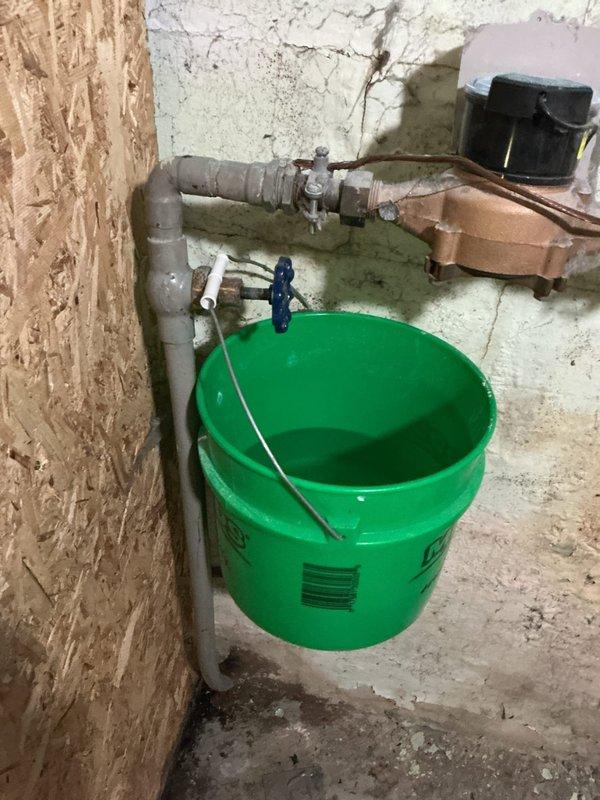 Responded to a main water shutoff valve leak in basement utility area. Upon inspection, confirmed active leak originating from the main ball valve assembly, not from the packing nut as initially suspected by homeowner. Attempted to tighten packing nut but leak persisted, indicating internal valve failure. Determined the ball valve was not repairable due to internal component deterioration. Shut off water supply at the meter and relieved system pressure. Removed failed ball valve and installed new replacement ball valve with proper thread sealant. Restored water service and pressure-tested the new installation to verify no leaks. Cleaned work area and removed old valve components from premises.