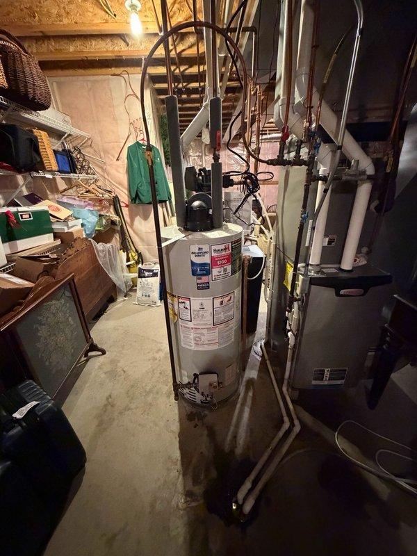 Removed and properly disposed of existing residential water heater from basement utility area. Installed new 40-gallon natural gas power vent water heater in same location. Connected copper supply lines to top of unit and verified all inlet/outlet connections for proper seal. Installed required PVC venting system for power vent exhaust. Configured gas line connection and tested for leaks using approved methods. Installed temperature and pressure relief valve with proper discharge piping. Filled tank, purged air from lines, and fired unit to verify proper ignition and burner operation. Tested all safety controls including high limit switch and thermal cutoff. Verified adequate combustion air supply and proper venting draft. Inspected surrounding area for water damage on concrete floor and confirmed no active leaks from new installation. All connections secured and system operational per manufacturer specifications.