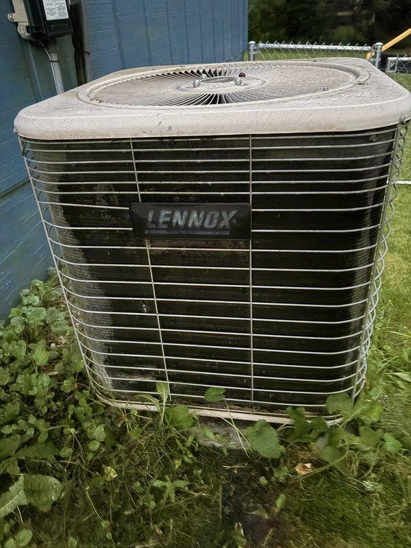 Responded to no-cool call on 22-year-old Lennox central air conditioning system. Upon arrival, found indoor blower operating but outdoor condenser unit buzzing without fan operation. Performed electrical diagnostics and identified failed capacitor as root cause. Replaced defective capacitor with new unit and performed condenser coil rinse-down to remove accumulated debris. System startup confirmed proper operation with 18-degree temperature split across evaporator coil. All functions tested and verified operational.