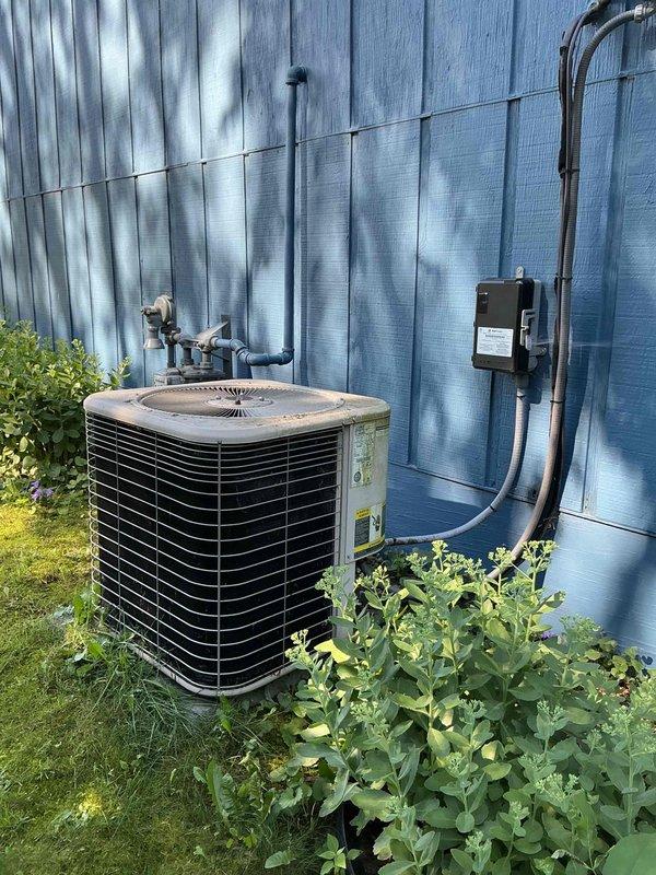 Responded to no-cool call on 22-year-old Lennox central air conditioning system. Upon arrival, found indoor blower operating but outdoor condenser unit buzzing without fan operation. Performed electrical diagnostics and identified failed capacitor as root cause. Replaced defective capacitor with new unit and performed condenser coil rinse-down to remove accumulated debris. System startup confirmed proper operation with 18-degree temperature split across evaporator coil. All functions tested and verified operational.