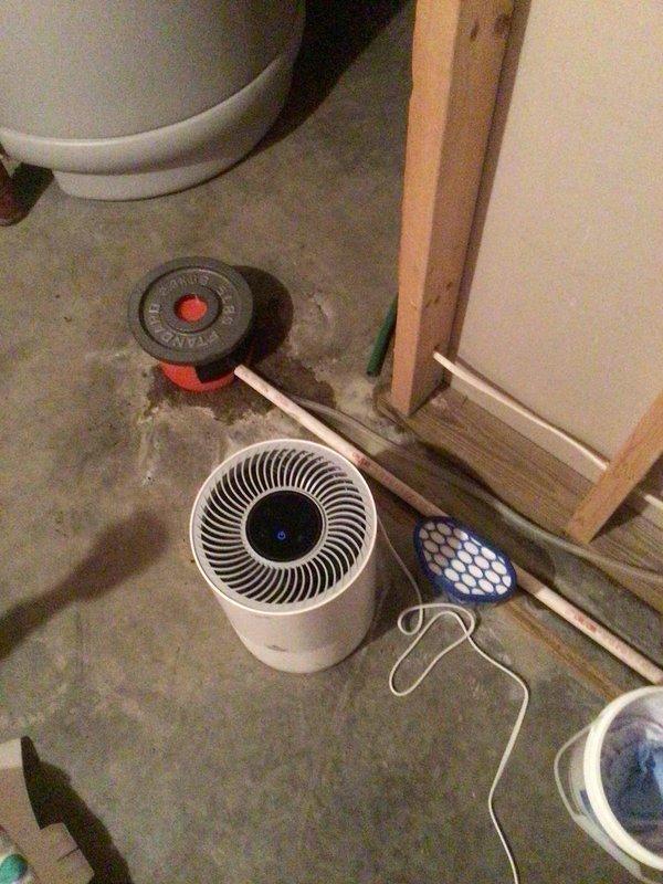 Responded to water leakage issue from 15-year-old HVAC system located in basement. Diagnosed and cleared clogged PVC elbow fitting at condensate drain line terminus, which was causing water overflow. Performed routine maintenance including replacement of air filter and AprilAire humidifier water panel as requested.