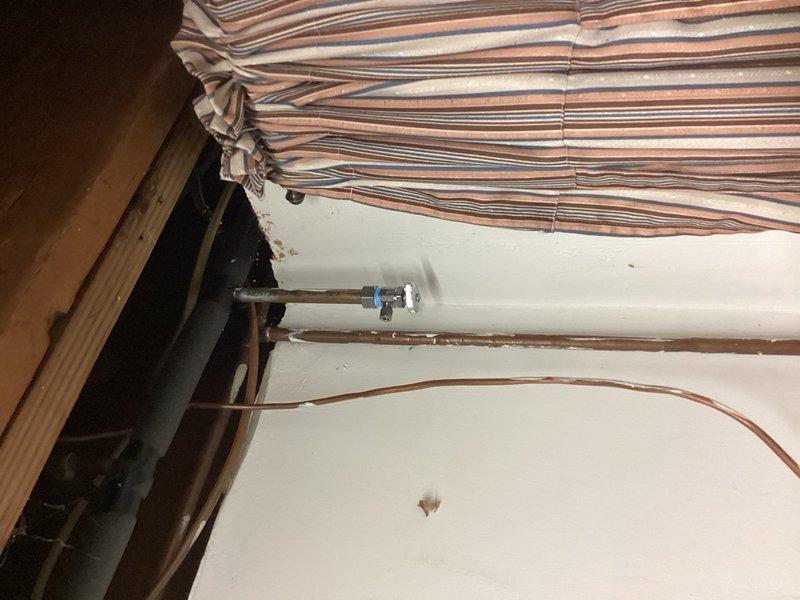 Responded to active water leak located behind refrigerator. Upon arrival, identified failed saddle T-valve as source of leak with water still active to home. Shut off main water supply to prevent further damage. Removed defective saddle T-valve and installed new compression stop valve to properly supply refrigerator water line. Tested installation for leaks, restored water service to home, and verified proper operation of new valve and refrigerator water connection.