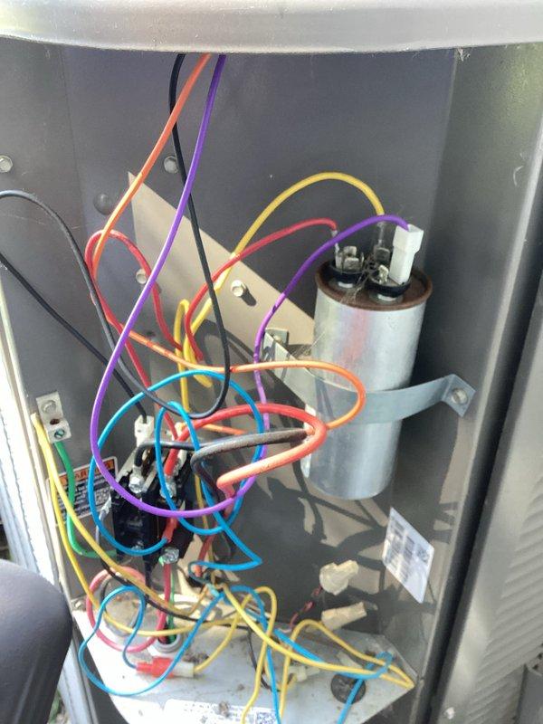 Responded to no cooling call on 12-year-old residential air conditioning system. Upon arrival, confirmed unit was not producing cool air. Performed diagnostic assessment of outdoor condenser unit and found heavily soiled condenser coils restricting airflow. Checked refrigerant charge levels and determined system was operating below manufacturer specifications, indicating potential refrigerant leak. Inspected electrical components, capacitor, and control panel wiring for proper operation. Documented findings with photos of indoor furnace/air handler installation and electrical control compartment. Explained to customer that condenser coil cleaning would be required first, followed by leak detection testing to locate source of refrigerant loss. Scheduled follow-up appointment with service advisor to review repair options and system replacement considerations given age of equipment.