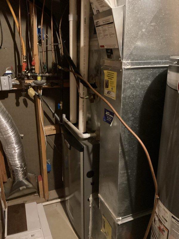 Responded to no cooling call on 12-year-old residential air conditioning system. Upon arrival, confirmed unit was not producing cool air. Performed diagnostic assessment of outdoor condenser unit and found heavily soiled condenser coils restricting airflow. Checked refrigerant charge levels and determined system was operating below manufacturer specifications, indicating potential refrigerant leak. Inspected electrical components, capacitor, and control panel wiring for proper operation. Documented findings with photos of indoor furnace/air handler installation and electrical control compartment. Explained to customer that condenser coil cleaning would be required first, followed by leak detection testing to locate source of refrigerant loss. Scheduled follow-up appointment with service advisor to review repair options and system replacement considerations given age of equipment.