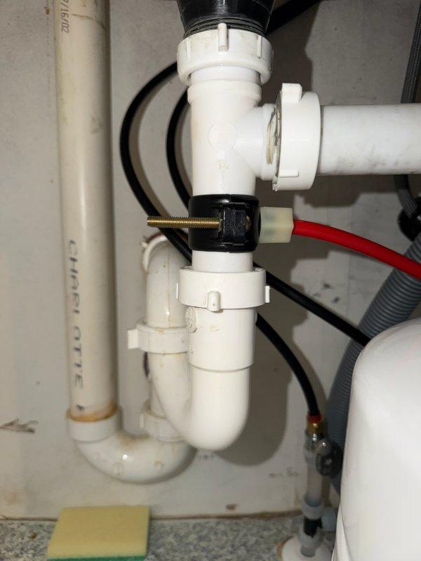 Responded to a water leak located under the kitchen sink originating from a reverse osmosis system. Upon arrival, found active leak from the RO drain line. During diagnostic inspection, discovered the reverse osmosis unit was operating without a flow restrictor, which is a critical component for proper system function and pressure regulation. Installed a complete reverse osmosis system with all required components, including the previously missing flow restrictor. Reconfigured and re-ran the drain line to connect properly to the standpipe for code-compliant drainage. Verified all connections were secure and tested the system for proper operation and absence of leaks. System is now functioning correctly with no active water leakage detected.