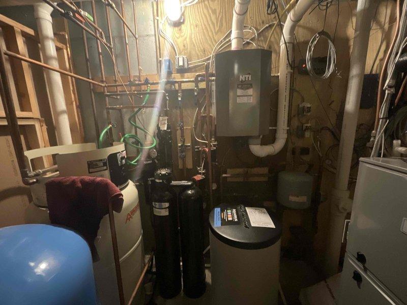 # HVAC Service Report

Responded to recurrent pressure loss issue in residential boiler system. Upon arrival, performed comprehensive inspection of NTI boiler unit and associated hydronic components including expansion tank, water heater, and filtration systems. This marked a follow-up visit for ongoing pressure loss concerns that were previously addressed approximately one month prior.

Conducted thorough pressure testing and visual inspection of all accessible piping connections, valves, and fittings throughout the boiler system. Examined copper piping runs, PVC venting, and interconnected plumbing components for signs of leakage or deterioration. Inspected the blue expansion tank for proper pre-charge pressure and functionality. Evaluated all mechanical connections at the boiler manifold and distribution lines.

Documented current system conditions with photographic evidence showing the complete mechanical room layout and equipment configuration. Previous service history was reviewe