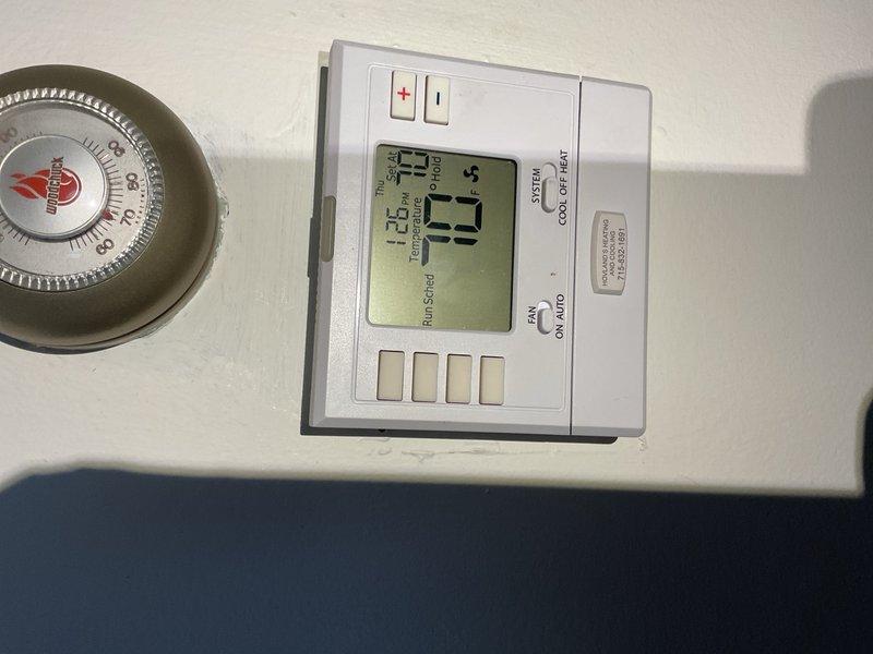 Responded to service call for air conditioning system reportedly running continuously during extreme heat conditions with outdoor temperatures approaching 100°F. Upon arrival, found residence maintaining setpoint of 70°F with indoor temperature matching thermostat setting. Inspected 2003 Rheem condensing unit utilizing R-22 refrigerant and identified partially blocked condenser coil restricting airflow. Performed condenser coil cleaning by rinsing exterior coil to restore proper heat transfer efficiency. Cycled system and measured supply air temperature split at 22°F, confirming adequate cooling capacity and normal refrigerant charge. Verified compressor operation, fan motor function, and overall system performance within manufacturer specifications. No mechanical defects or refrigerant leaks detected during inspection. Educated customer on expected extended runtime characteristics during peak ambient conditions, particularly for aging R-22 equipment operating at design limits. System 