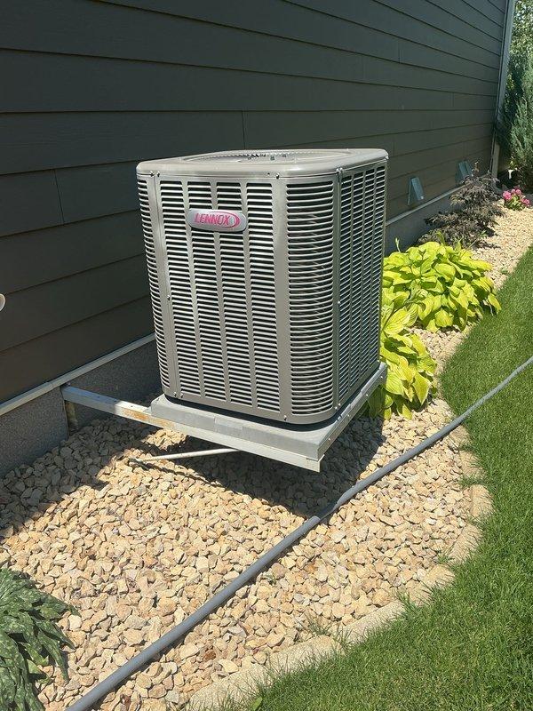 Responded to service call for 11-year-old Lennox AC system unable to maintain desired temperature of 73 degrees, only reaching 78 degrees. Upon inspection, diagnosed system as low on obsolete refrigerant, causing intermittent indoor coil freezing that resulted in inconsistent cooling performance and restricted airflow. Documented equipment condition with photos of outdoor condenser unit and indoor air handler/furnace system. Provided customer with repair options and recommended system replacement due to age and obsolete refrigerant type. Scheduled follow-up estimate appointment for new AC installation.