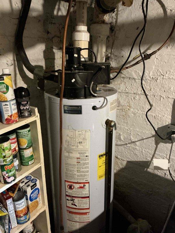 Responded to no hot water call for malfunctioning water heater. Upon inspection, found 22-year-old Kenmore tank-style water heater in failed condition with visible corrosion on copper piping connections and unit in lockout mode. Assessed unit as beyond economical repair due to age and condition. Provided estimate for electric water heater replacement and submitted financing application for customer approval.