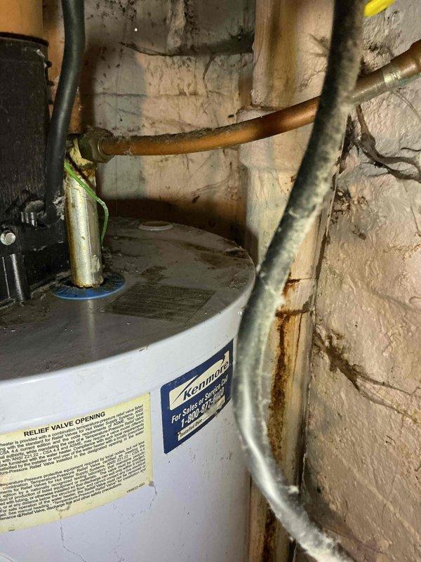 Responded to no hot water call for malfunctioning water heater. Upon inspection, found 22-year-old Kenmore tank-style water heater in failed condition with visible corrosion on copper piping connections and unit in lockout mode. Assessed unit as beyond economical repair due to age and condition. Provided estimate for electric water heater replacement and submitted financing application for customer approval.