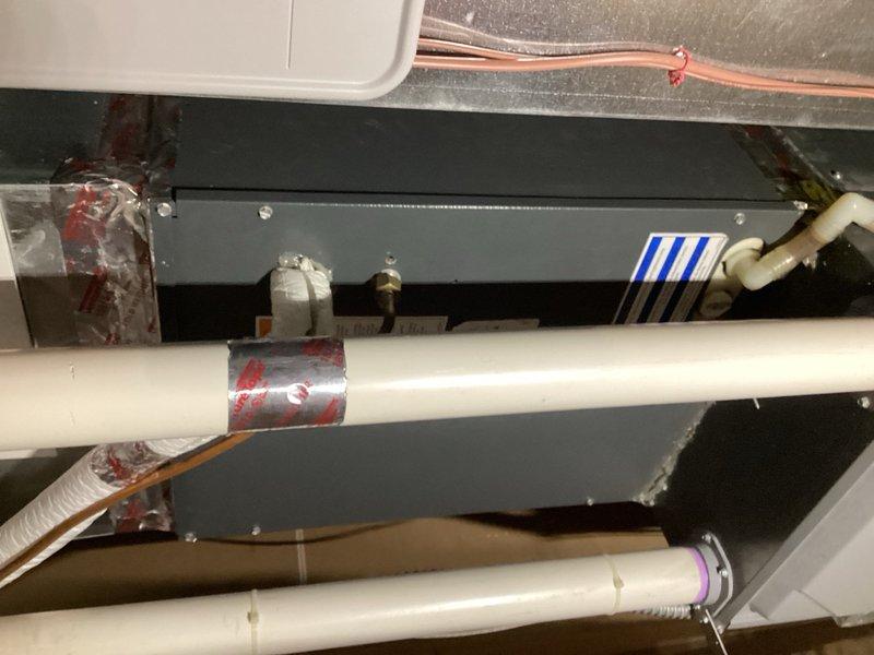 Responded to return service call for air conditioning system blowing warm air with insufficient cooling. Performed comprehensive diagnostic evaluation including inspection of condenser components, capacitor, contactor, compressor, evaporator coil, blower assembly, and zone dampers. Verified all dampers operating in open position. Measured temperature split at only 8°, indicating inadequate system performance. Connected gauges and confirmed refrigerant charge at proper levels with superheat readings within manufacturer's recommended specifications. Analysis revealed elevated saturation pressure pointing to metering device malfunction restricting proper refrigerant flow and system operation. Documented findings with photographic evidence of evaporator coil assembly and internal components. Recommended replacement of faulty metering device to restore proper cooling capacity. Submitted parts order request for required components to complete repair.