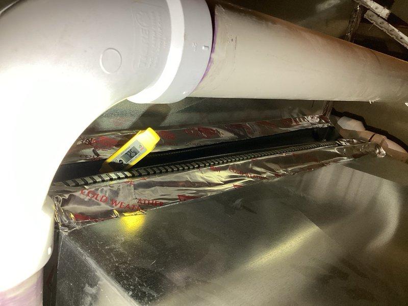 Responded to return service call for air conditioning system blowing warm air with insufficient cooling. Performed comprehensive diagnostic evaluation including inspection of condenser components, capacitor, contactor, compressor, evaporator coil, blower assembly, and zone dampers. Verified all dampers operating in open position. Measured temperature split at only 8°, indicating inadequate system performance. Connected gauges and confirmed refrigerant charge at proper levels with superheat readings within manufacturer's recommended specifications. Analysis revealed elevated saturation pressure pointing to metering device malfunction restricting proper refrigerant flow and system operation. Documented findings with photographic evidence of evaporator coil assembly and internal components. Recommended replacement of faulty metering device to restore proper cooling capacity. Submitted parts order request for required components to complete repair.