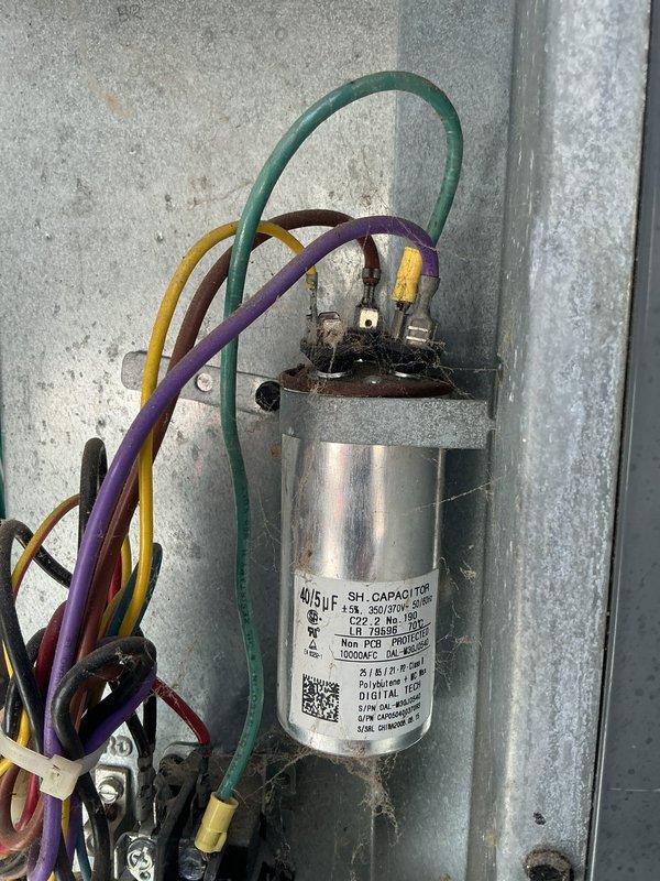 Responded to no cooling complaint on aging air conditioning system. Found outdoor condenser unit heavily plugged with debris restricting airflow and a failed dual-run capacitor. Thoroughly cleaned condenser coil to restore proper airflow, then replaced defective capacitor with new 40/5μF unit. Verified system operation with refrigerant pressure readings within manufacturer specifications. Unit restored to normal cooling operation.