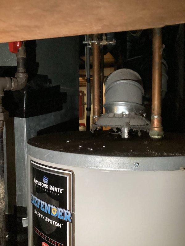 Responded to no hot water call for Bradford White natural gas water heater with Defender Safety System. Unit failed to maintain burner operation following gas service interruption caused by utility company gas line damage in area. Utility personnel previously attempted unsuccessful relight. Upon inspection, confirmed burner would not stay lit, indicating likely damage to gas valve or thermocouple assembly from initial incident. Documented existing installation including copper supply lines, shut-off valves, and adjacent water treatment equipment. Captured detailed photographs of unit model/serial information, plumbing connections, and overall installation for utility company claim documentation. Replaced water heater to restore hot water service to residence.